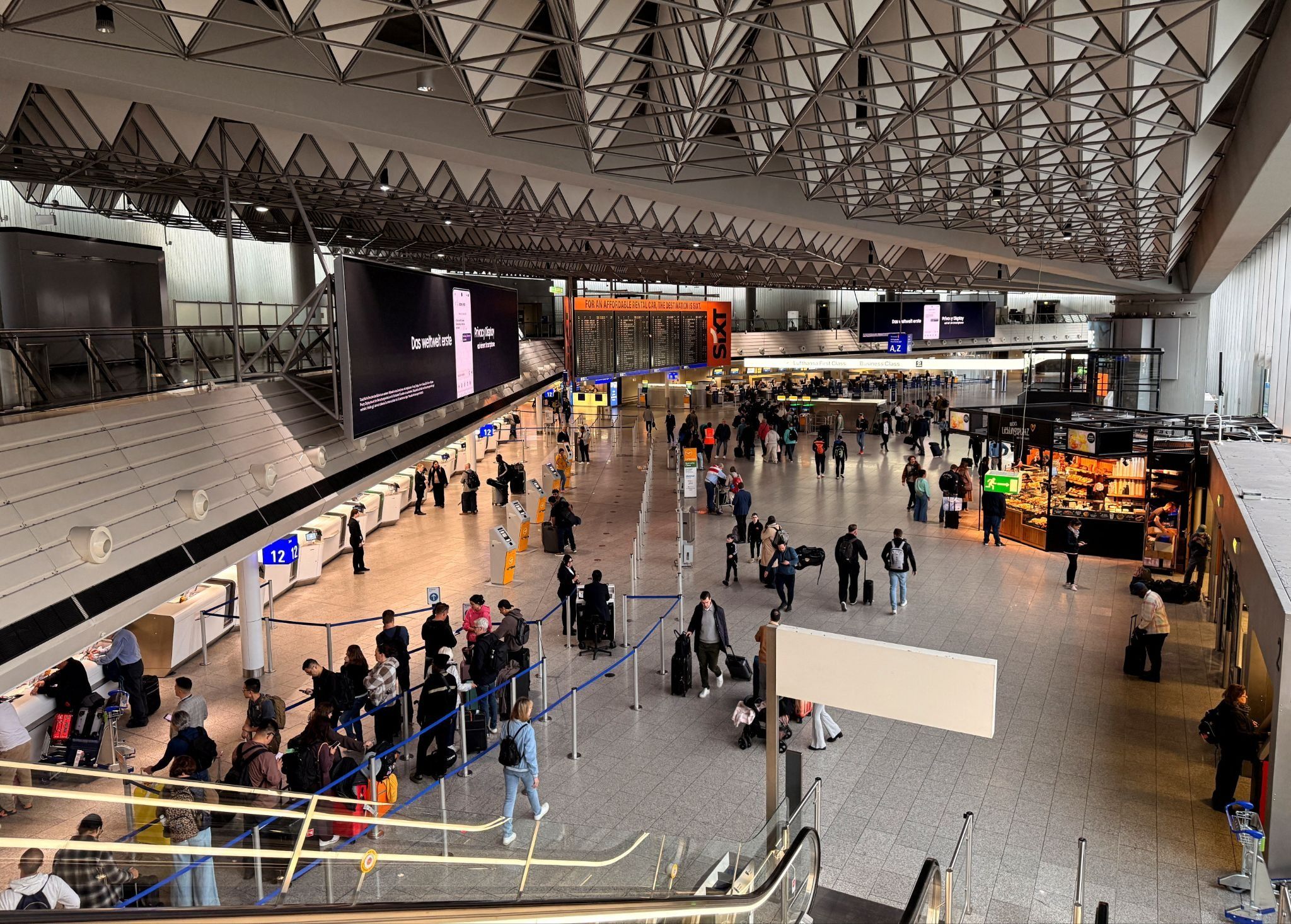 People walk at Terminal 1 during a strike of Cockpit, the union representing Lufthansa pilots, at Frankfurt Airport, Germany