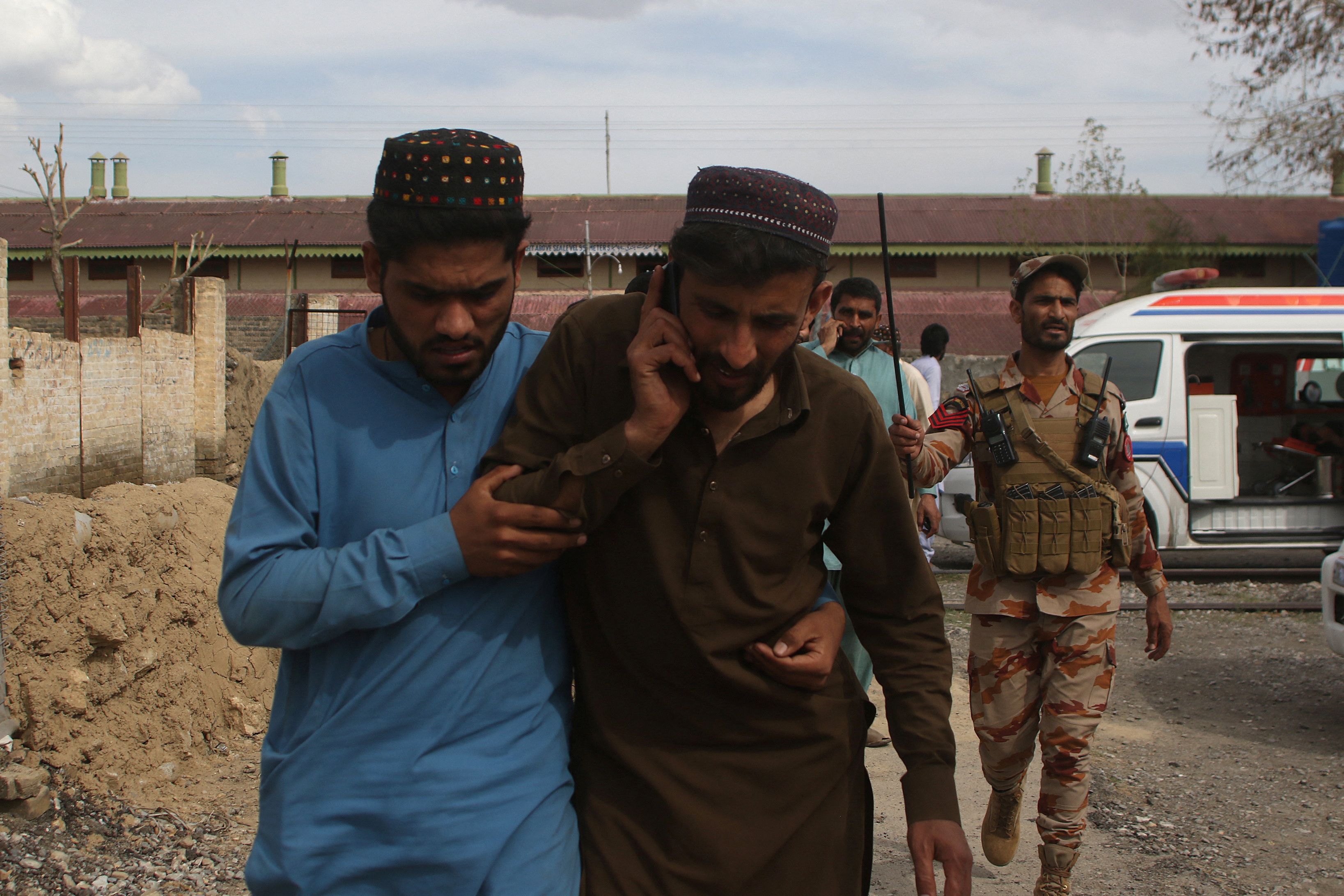 Plain clothes security force perosnnel, who were rescued from a train after it was attacked by separatist militants, leave Mach railway station in Mach, Balochistan, Pakistan.