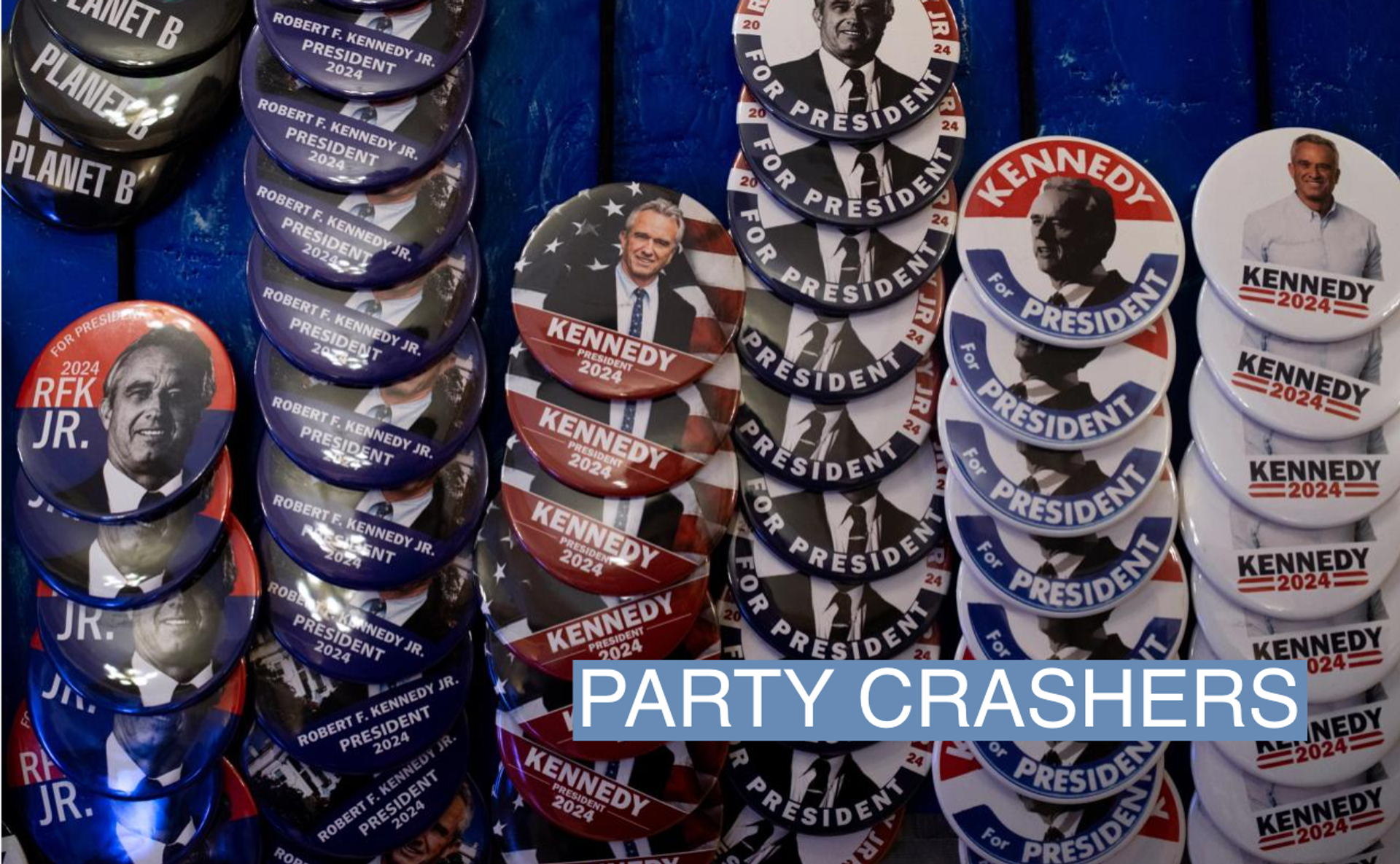 Pins and other merchandise in support of independent presidential candidate Robert F. Kennedy Jr. on display during a voter rally on Feb. 10, 2023 in Grand Rapids, Mich.