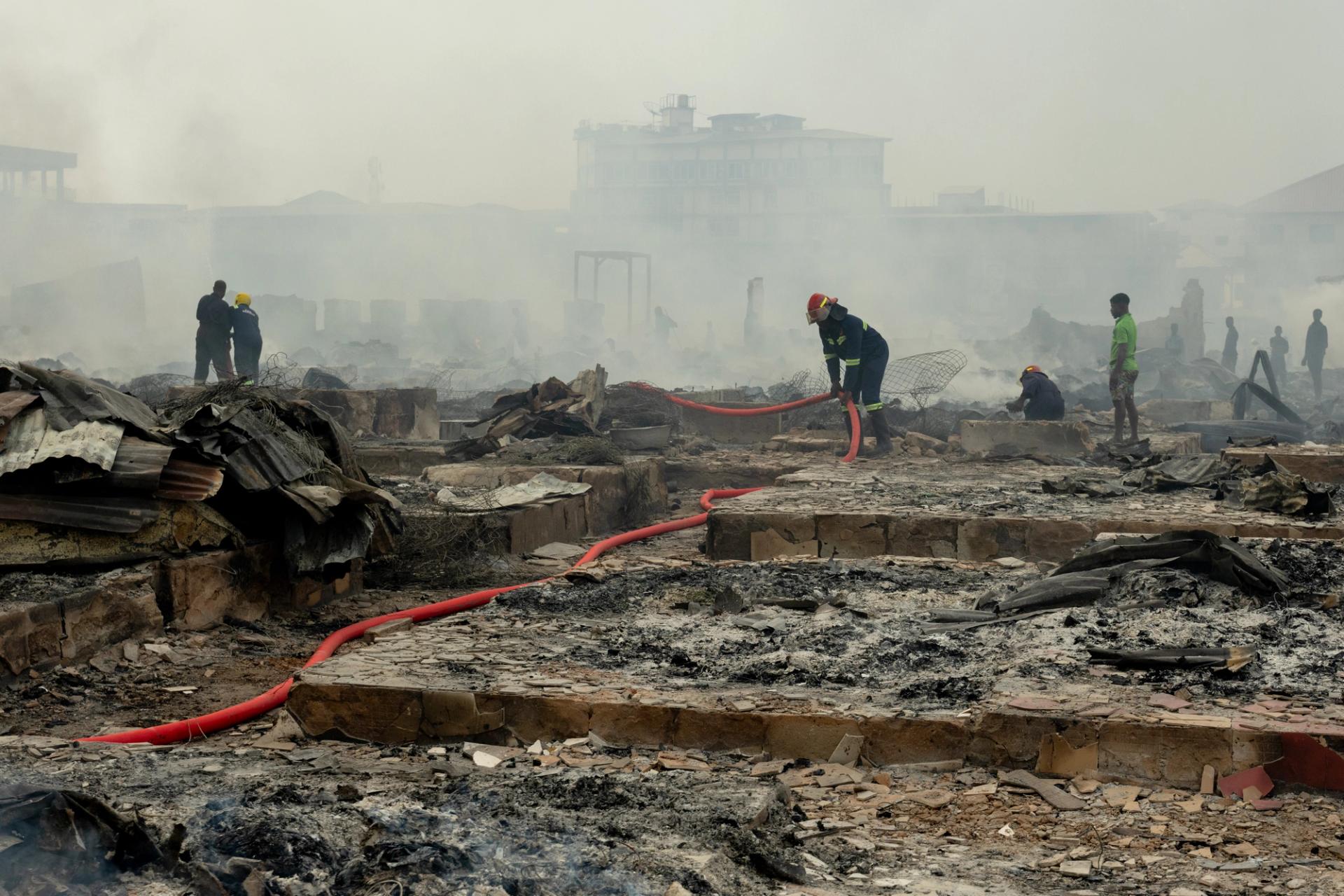 Firefighters work to put out the fire at Kantamanto Market in Accra, Ghana.