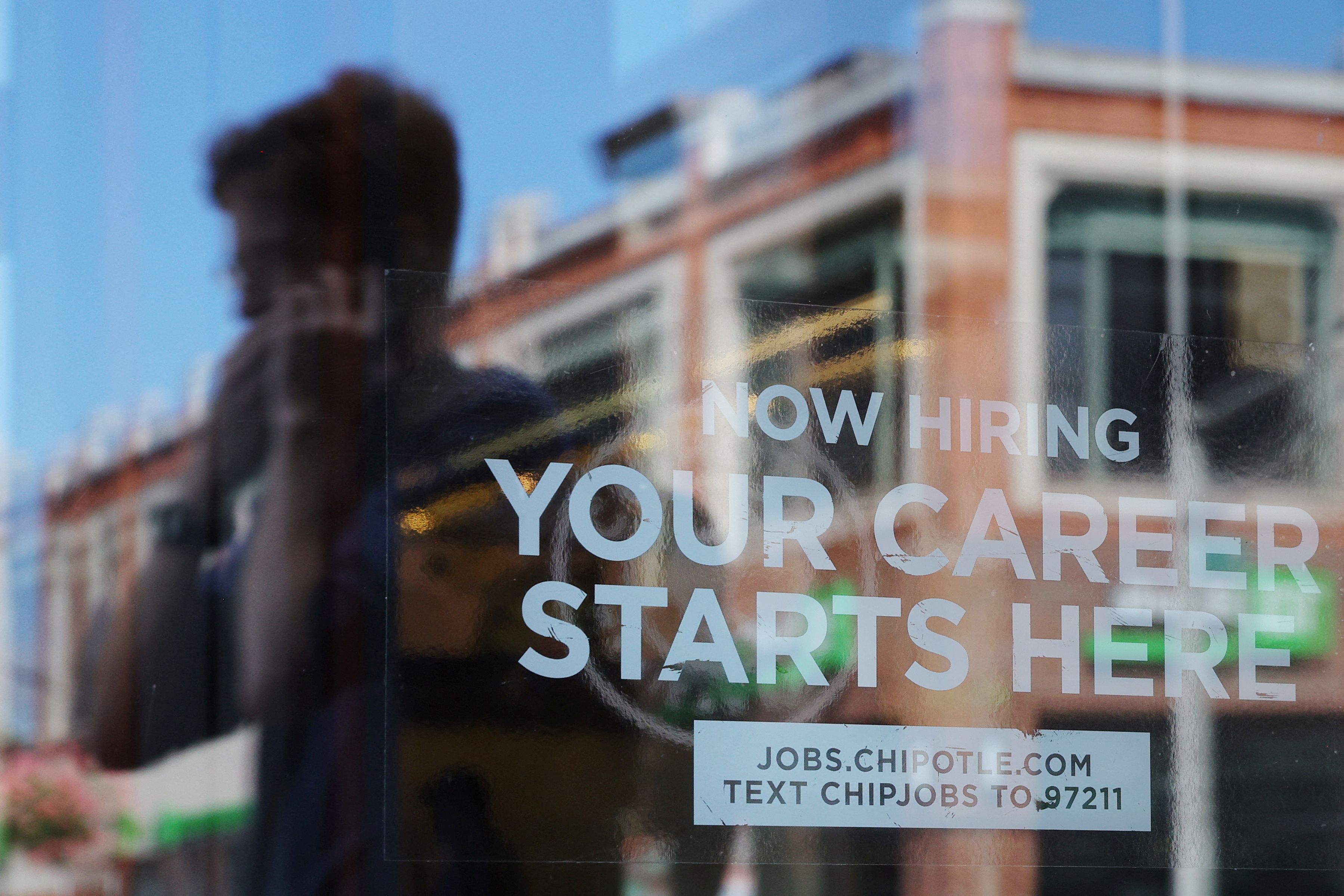 A Chipotle restaurant advertises it is hiring in Cambridge, Massachusetts. 