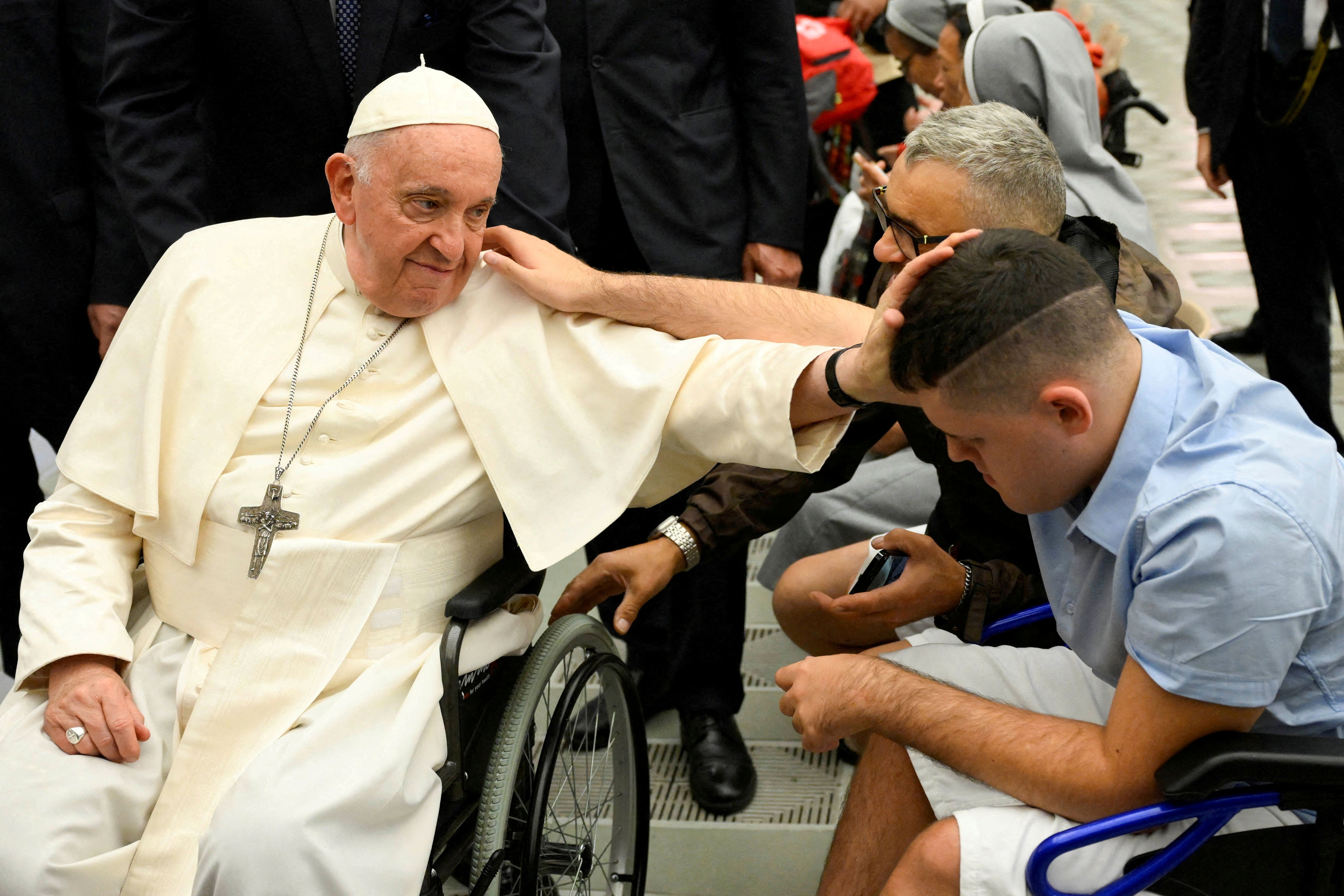 Pope Francis blesses a faithful during the weekly general audience in Paul VI hall at the Vatican in 2023.