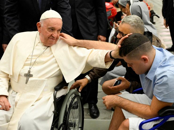 Pope Francis blesses a faithful during the weekly general audience in Paul VI hall at the Vatican in 2023.