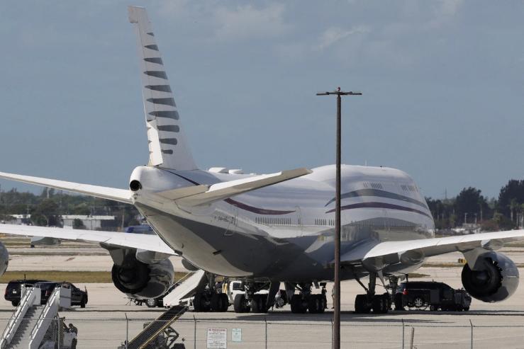 The motorcade of US President Donald Trump is parked next to a 12-year old Qatari-owned Boeing 747-8 that Trump was touring in West Palm Beach, Florida.