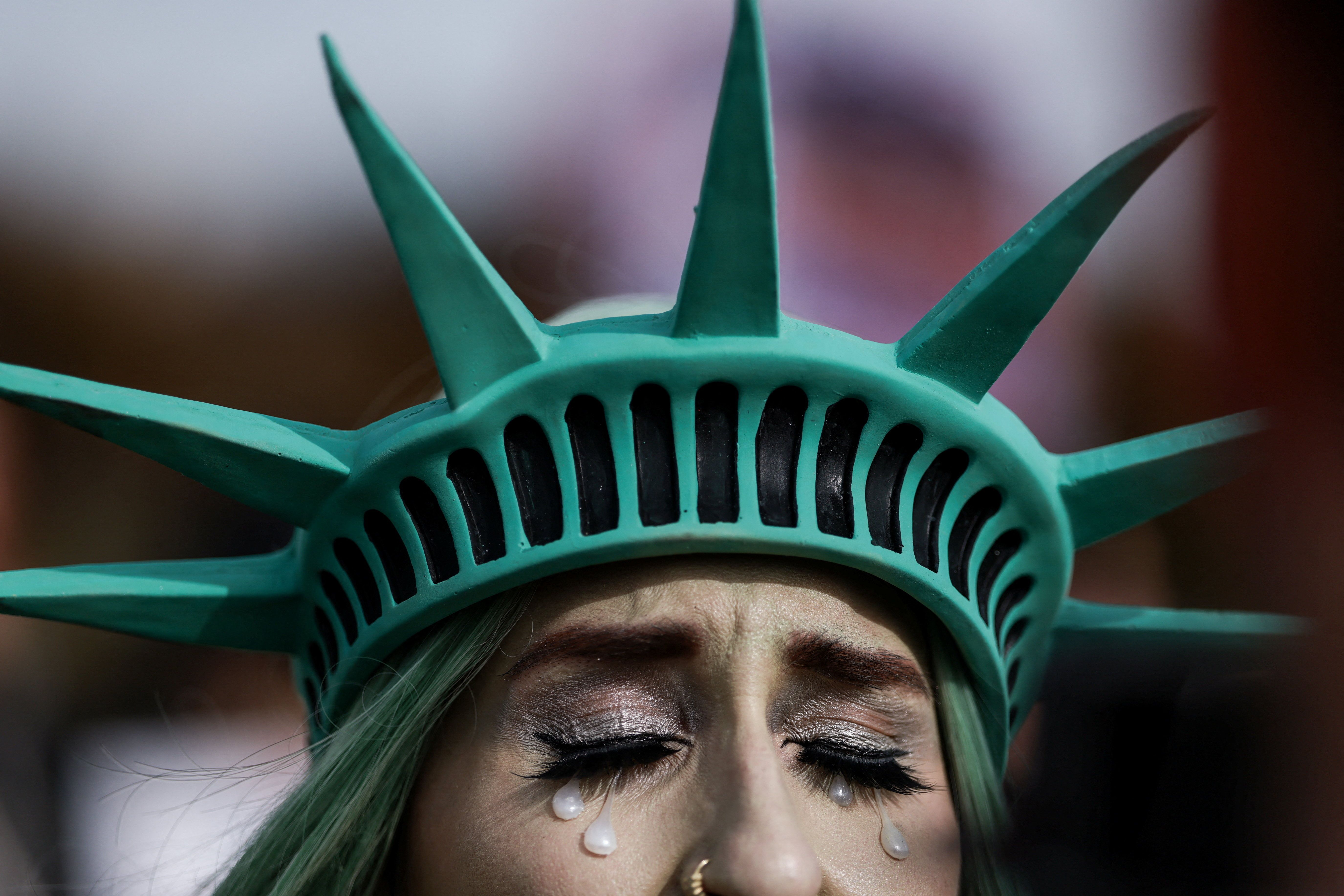 A protester dressed like a crying Statue of Liberty