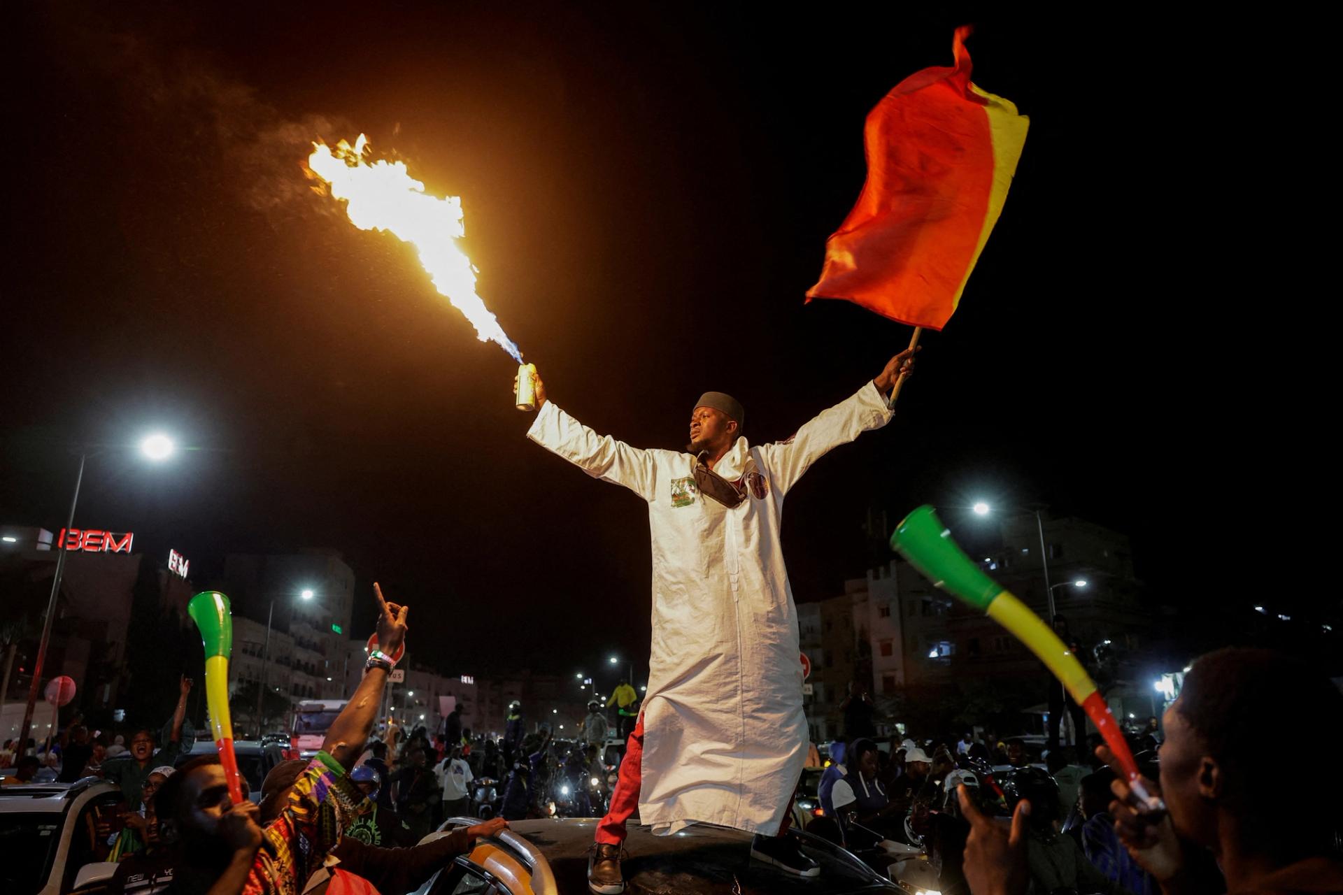 A supporter celebrates after Senegalese opposition leader Ousmane Sonko and the presidential candidate he is backing in the March 24 election, Bassirou Diomaye Faye were released from prison, in Dakar, Senegal March 14, 2024