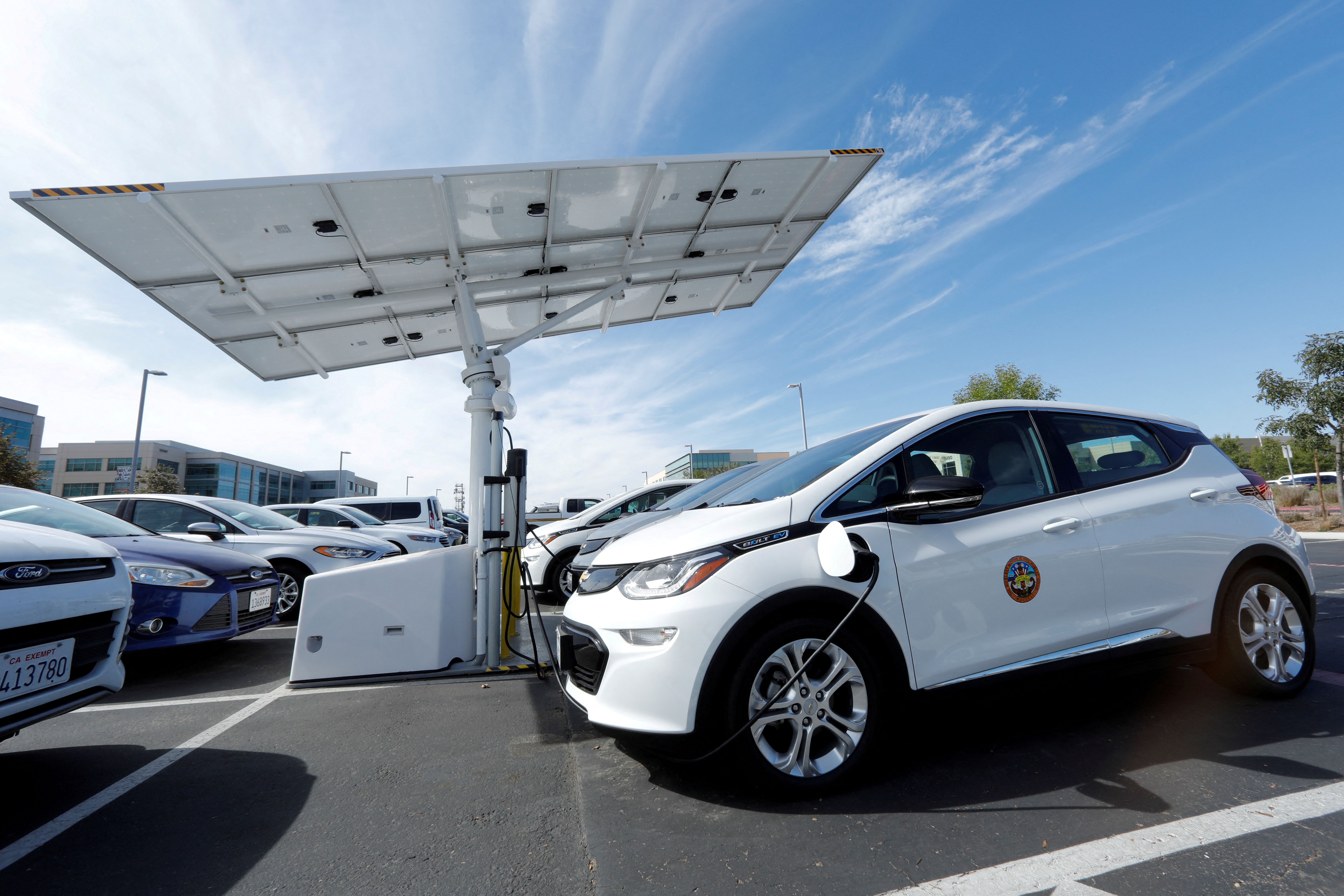 Chevrolet Bolt vehicles are charged by a sun tracking solar panel car charing system in San Diego.