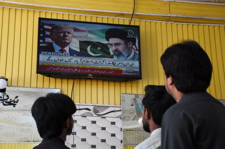 A TV showing Trump and a Pakistan flag.