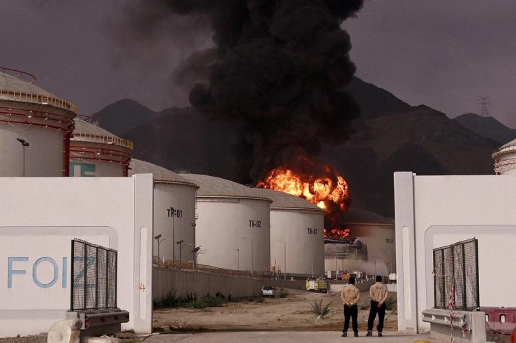 Fire and smoke rise in the Fujairah oil industry zone, caused by debris after interception of a drone by air defenses, according to the Fujairah media office, amid the U.S.-Israel conflict with Iran, in Fujairah, United Arab Emirates