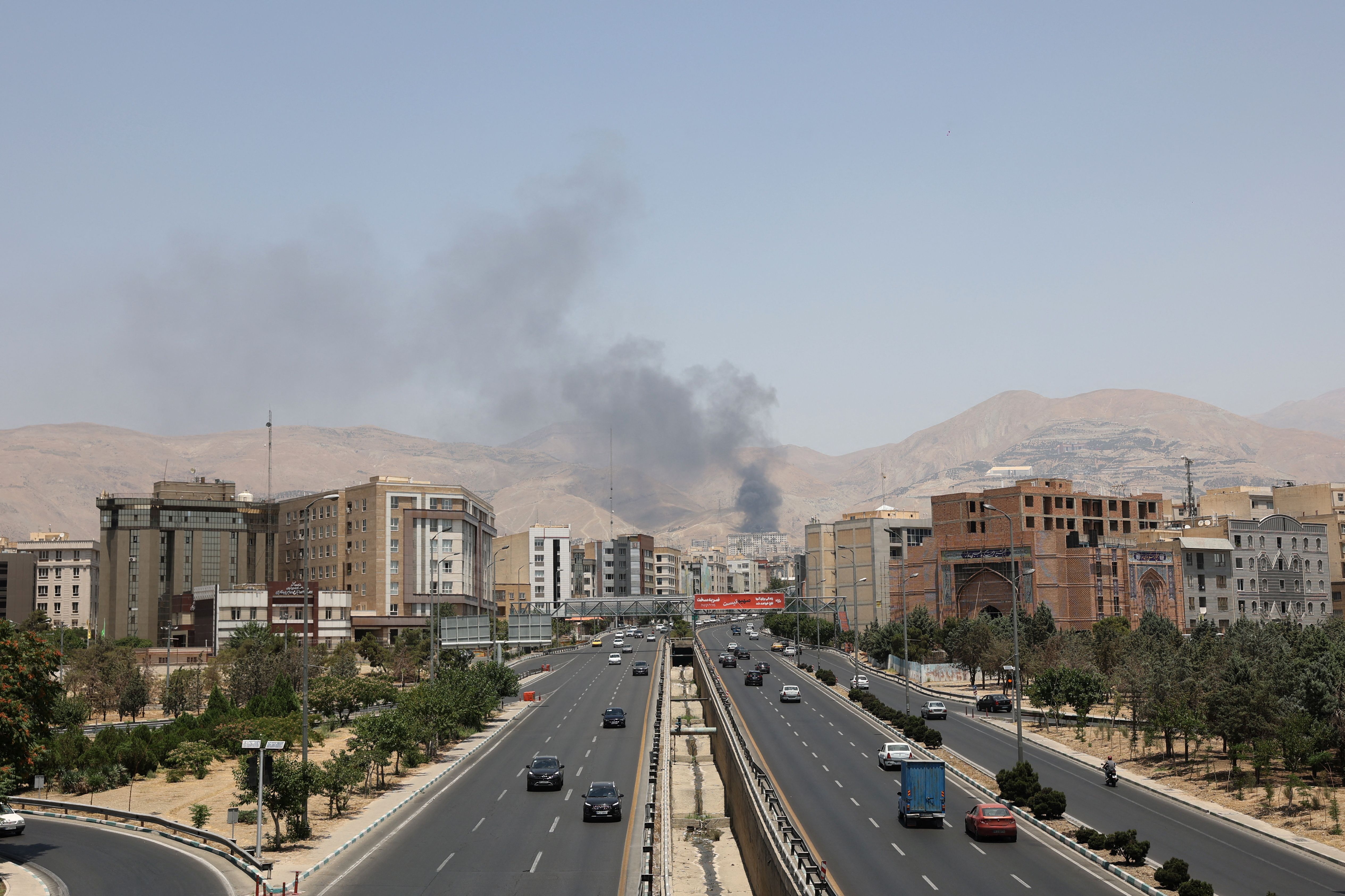 Smoke rises following what Iran says was an Israeli attack on Sharan Oil depot in Tehran.