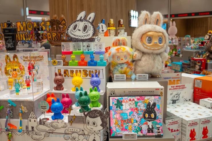 Various Labubu toys displayed on a shelf in the Pop Mart shop.