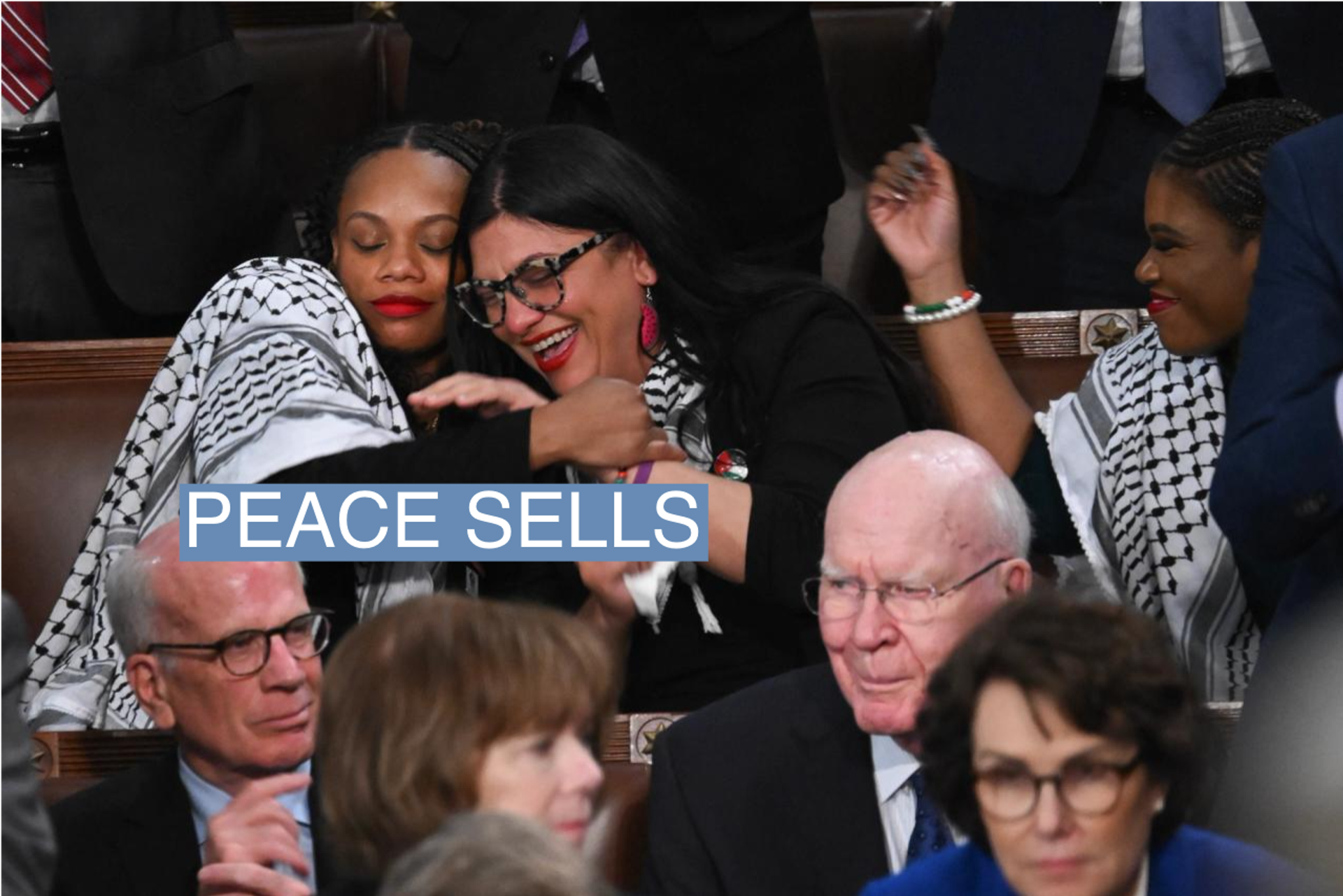 Rep. Summer Lee embraces Rep. Rashida Tlaib as President Joe Biden delivers the State of the Union address on March 7, 2024. 