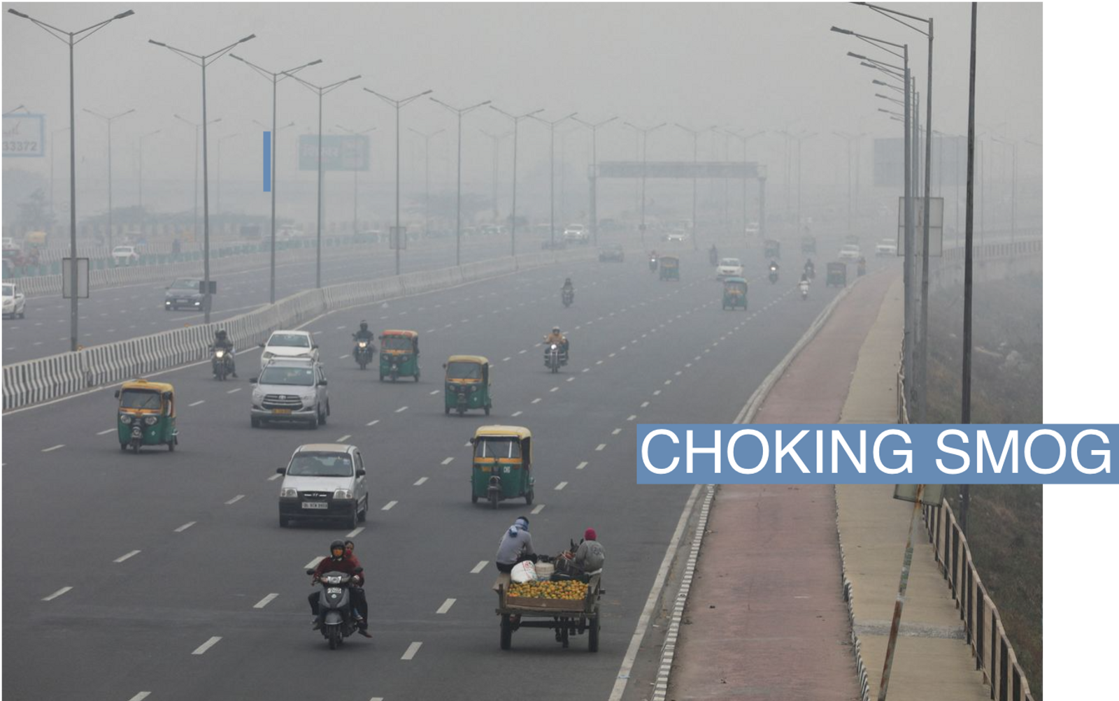 Vehicles are seen on a highway on a smoggy morning in New Delhi, India