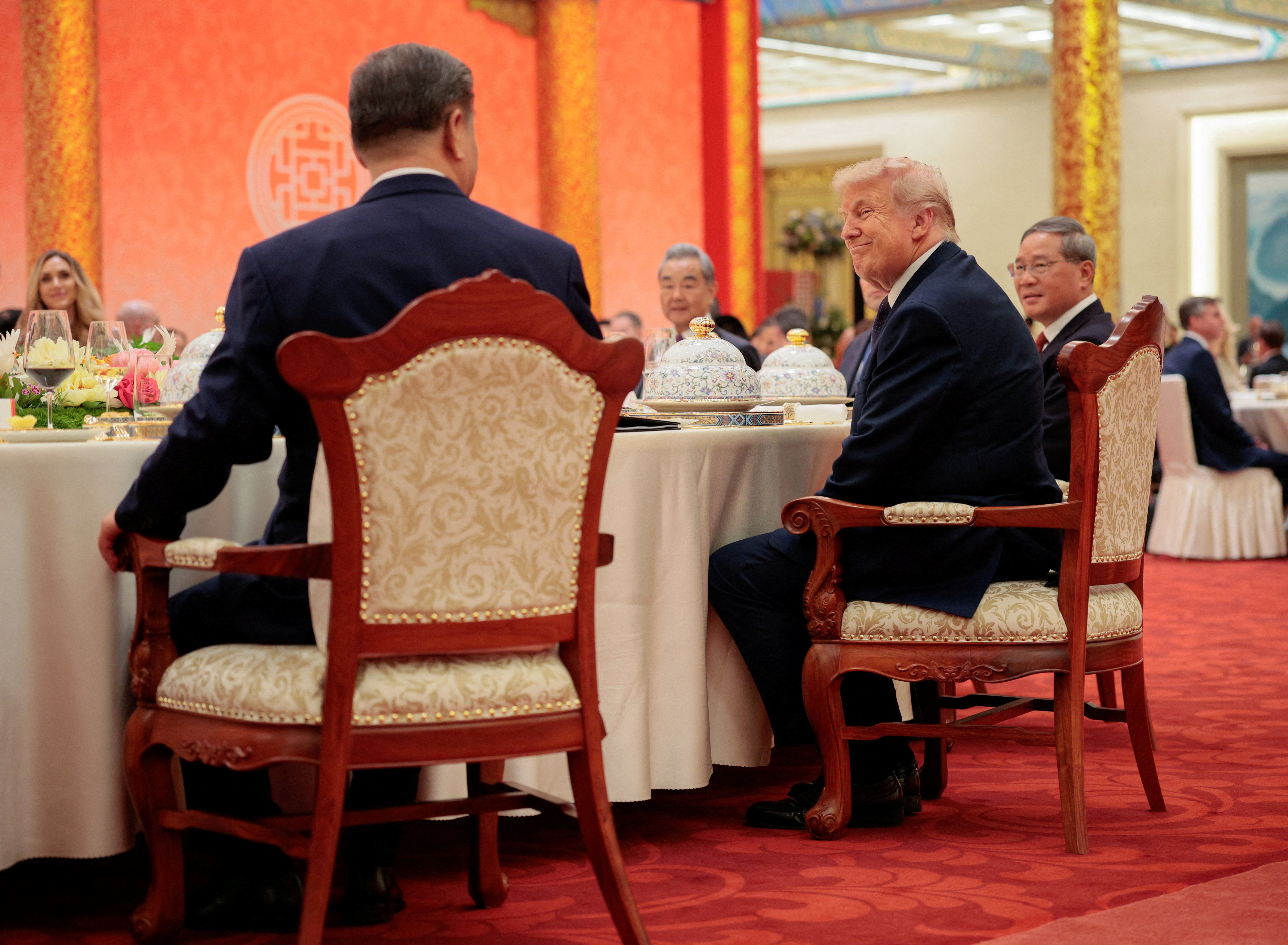 U.S. President Donald Trump reacts next to Chinese President Xi Jinping at a state banquet at the Great Hall of the People in Beijing, China, May 14, 2026. 