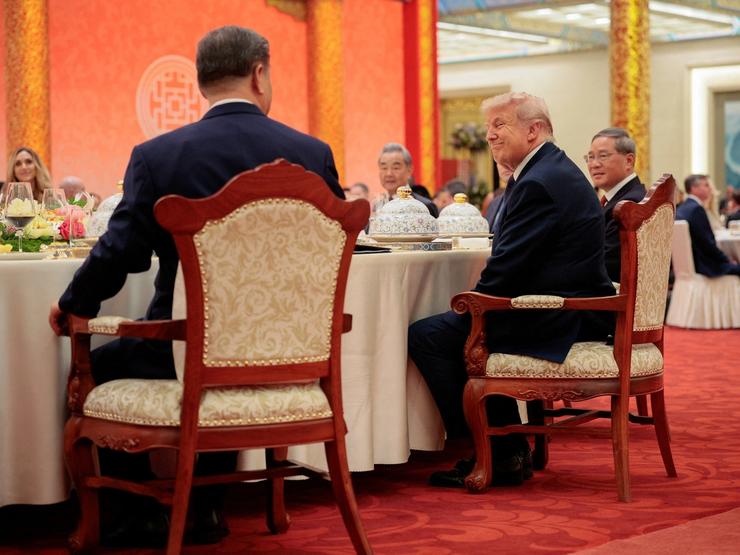 U.S. President Donald Trump reacts next to Chinese President Xi Jinping at a state banquet at the Great Hall of the People in Beijing, China, May 14, 2026.