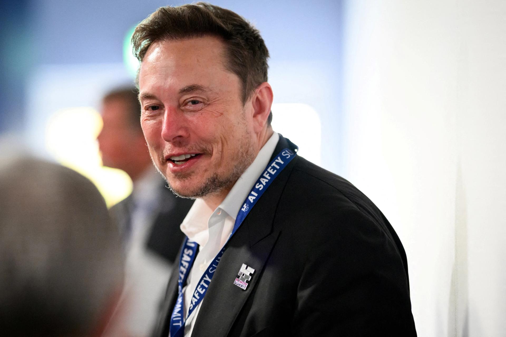 FILE PHOTO: Tesla, X (formerly known as Twitter) and SpaceX’s CEO Elon Musk speaks with other delegates on Day 1 of the AI Safety Summit at Bletchley Park in Bletchley, Britain on November 1, 2023. Leon Neal/Pool via REUTERS/File Photo