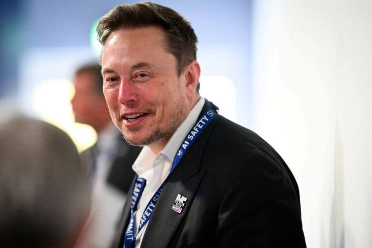 FILE PHOTO: Tesla, X (formerly known as Twitter) and SpaceX’s CEO Elon Musk speaks with other delegates on Day 1 of the AI Safety Summit at Bletchley Park in Bletchley, Britain on November 1, 2023. Leon Neal/Pool via REUTERS/File Photo