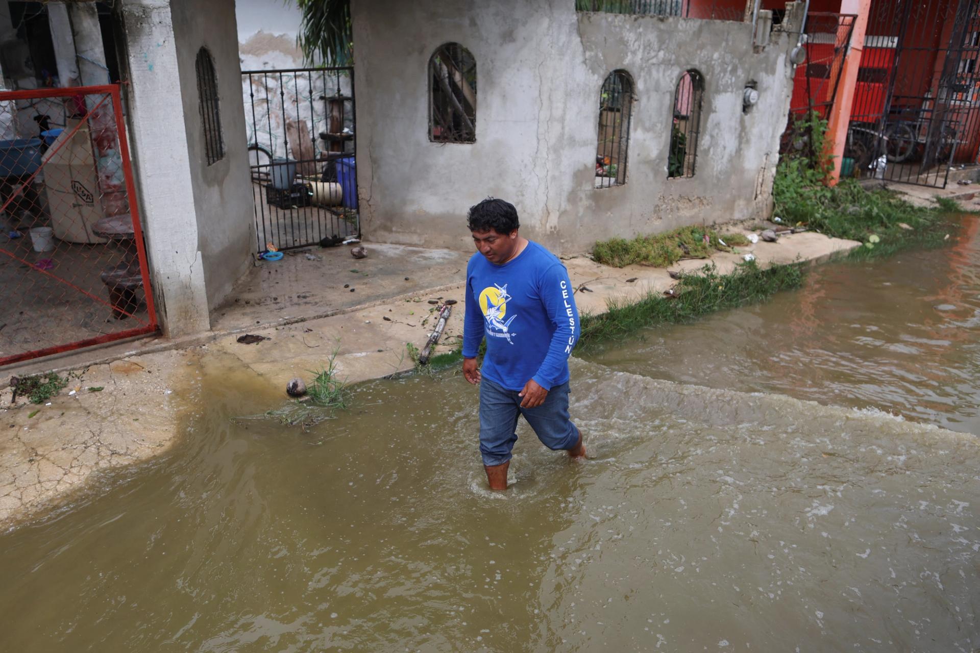 A man walks through floodwaters after Hurricane Milton brought heavy rain to Mexico’s Yucatan Peninsula.