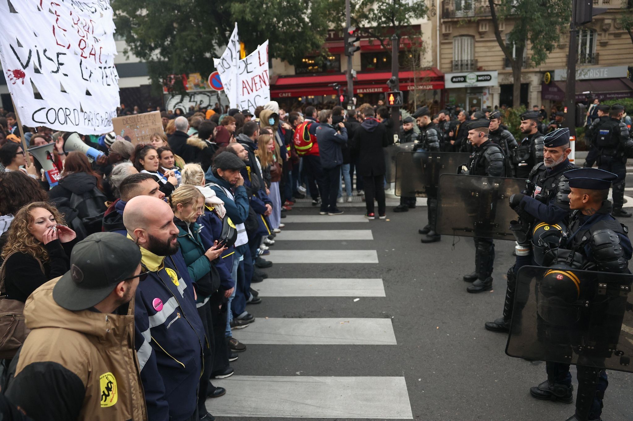 Police officers block the street during a protest organized by student collectives and trade unions in Paris, France.