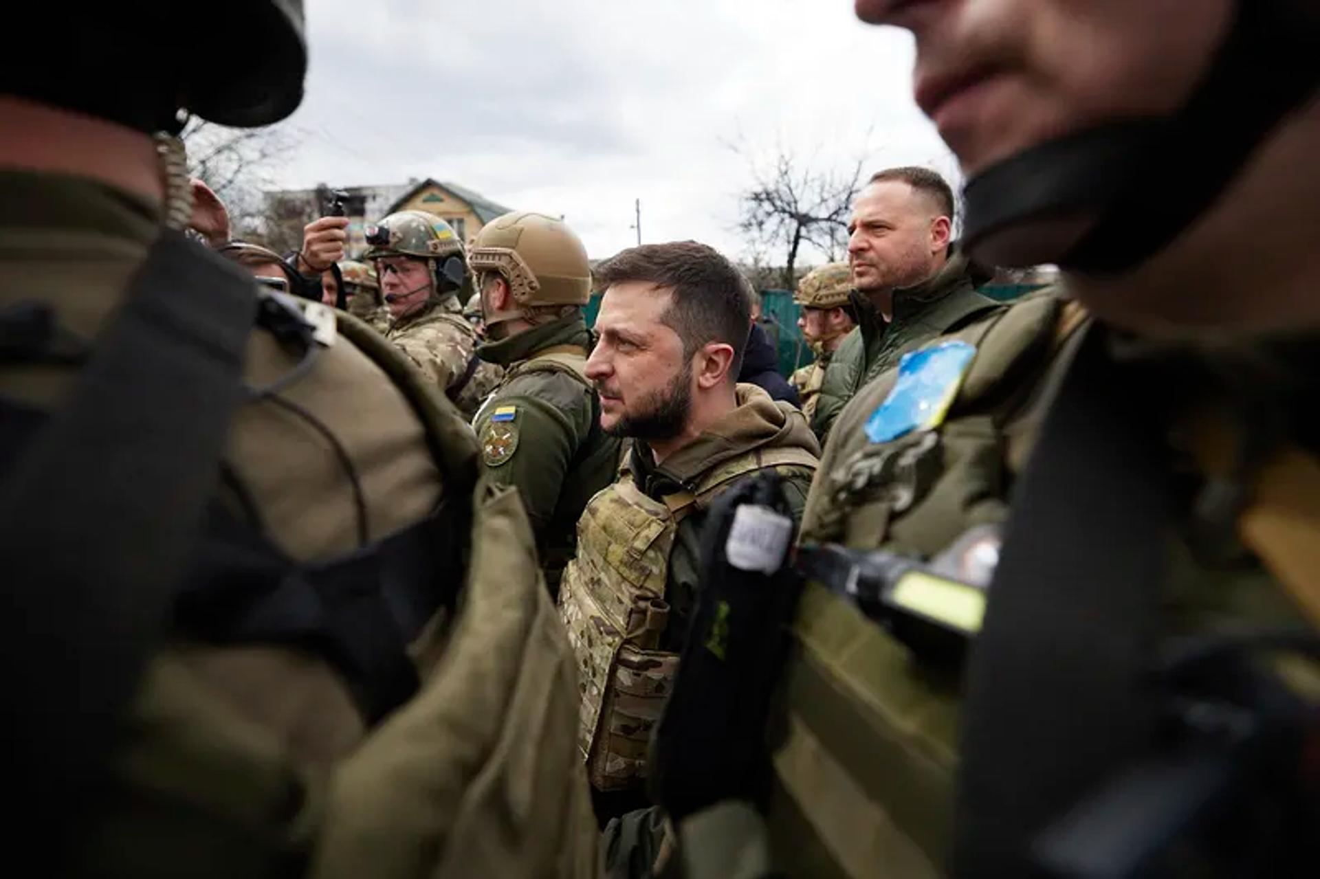 Ukrainian President Vlodymmyr Zelenskyy pictured in a protective vest, with troops 