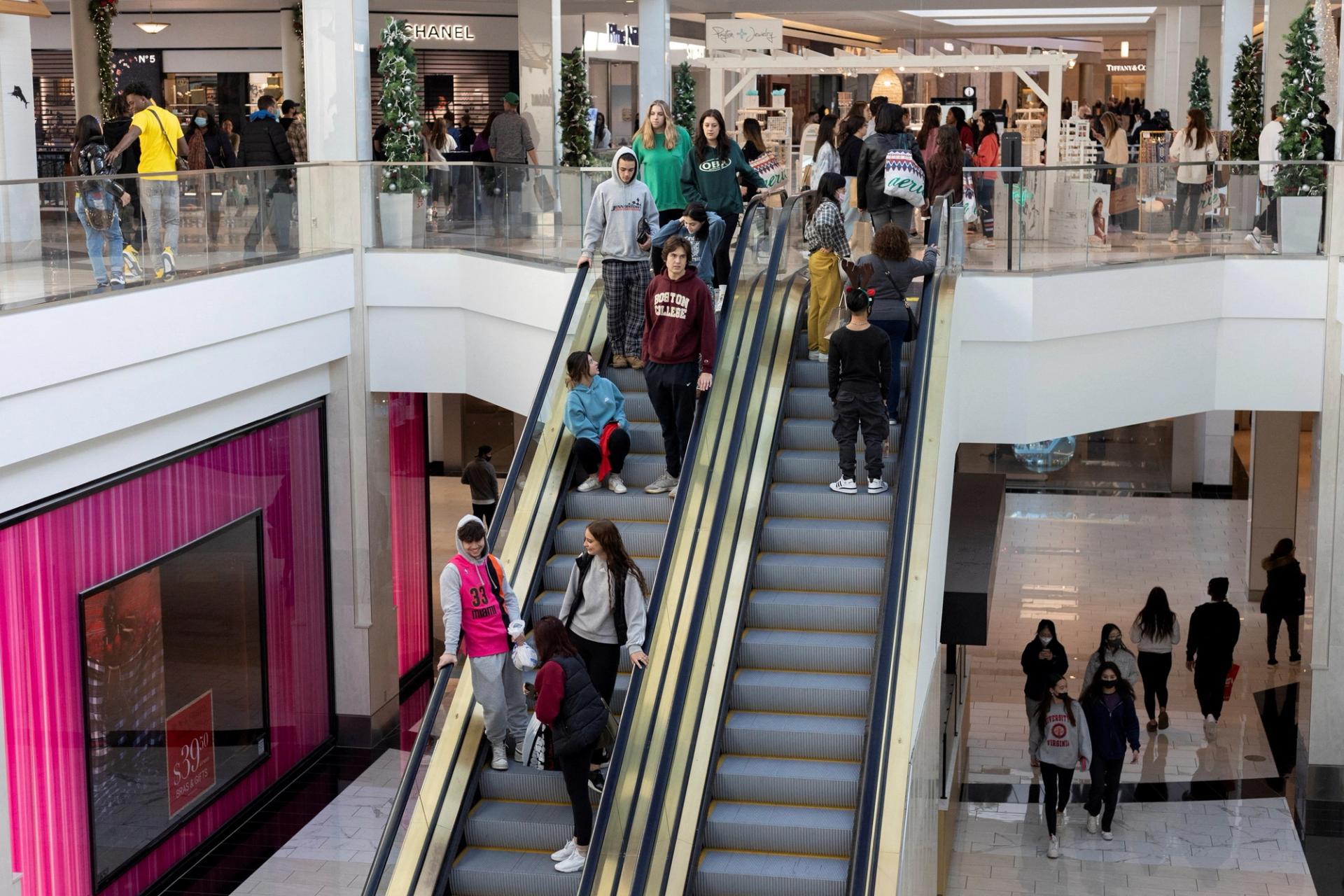 People ride on the elevator as shoppers show up early for the Black Friday sales at the King of Prussia shopping mall in King of Prussia, Pennsylvania, November 26, 2021. 