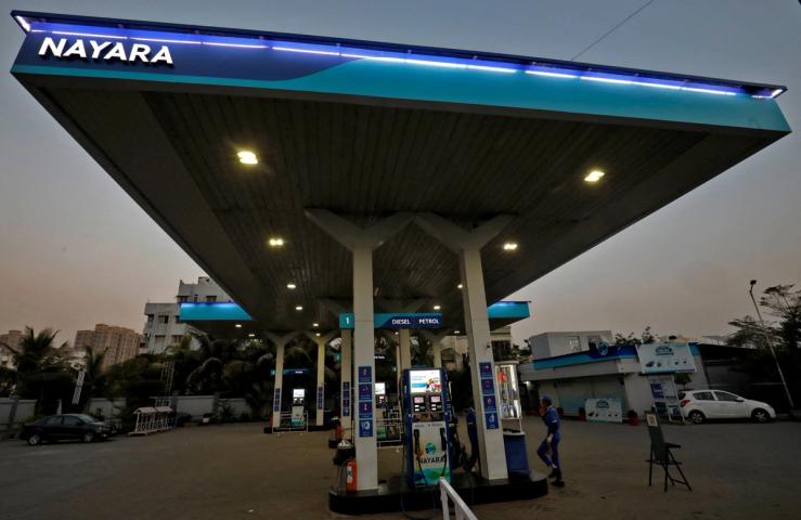 A worker stands at a fuel station of Nayara Energy on the outskirts of Ahmedabad, India