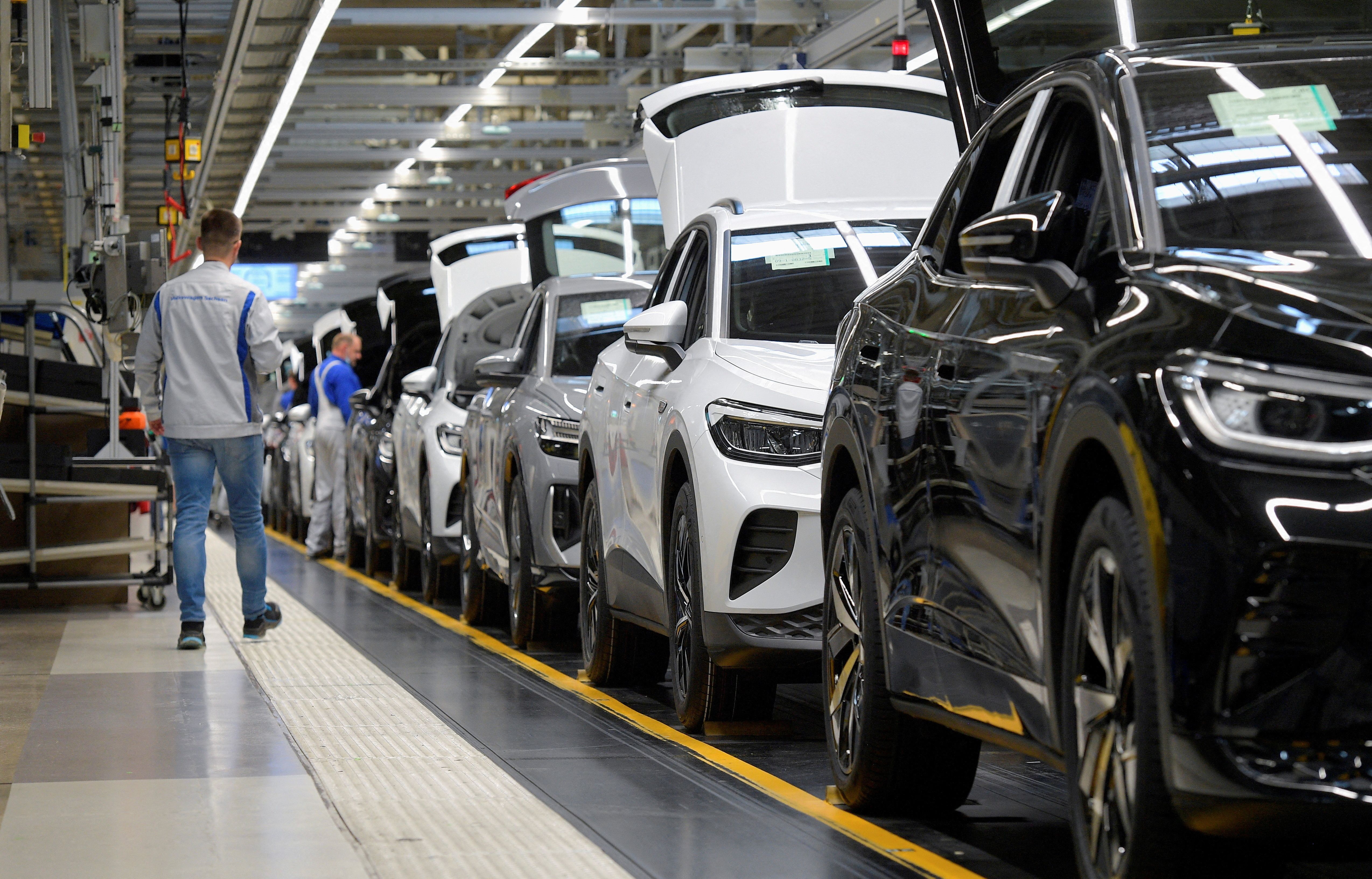 Technicians work at the production line for electric car models of the Volkswagen Group in Zwickau, Germany.