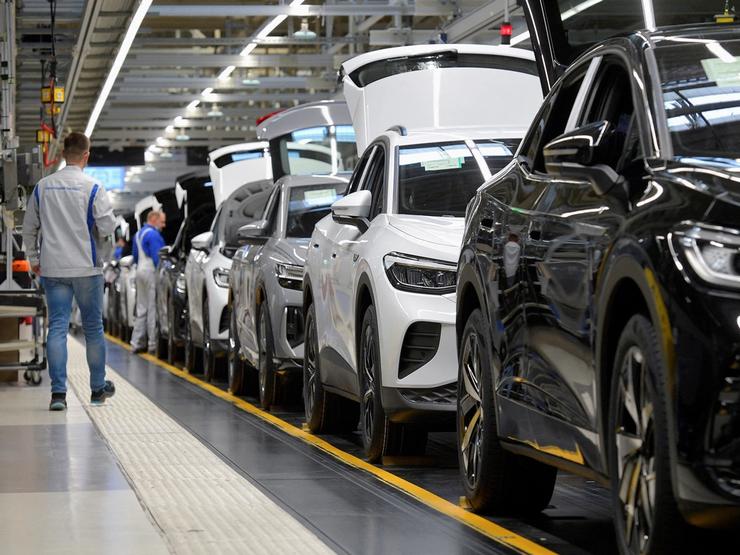 Technicians work at the production line for electric car models of the Volkswagen Group in Zwickau, Germany.