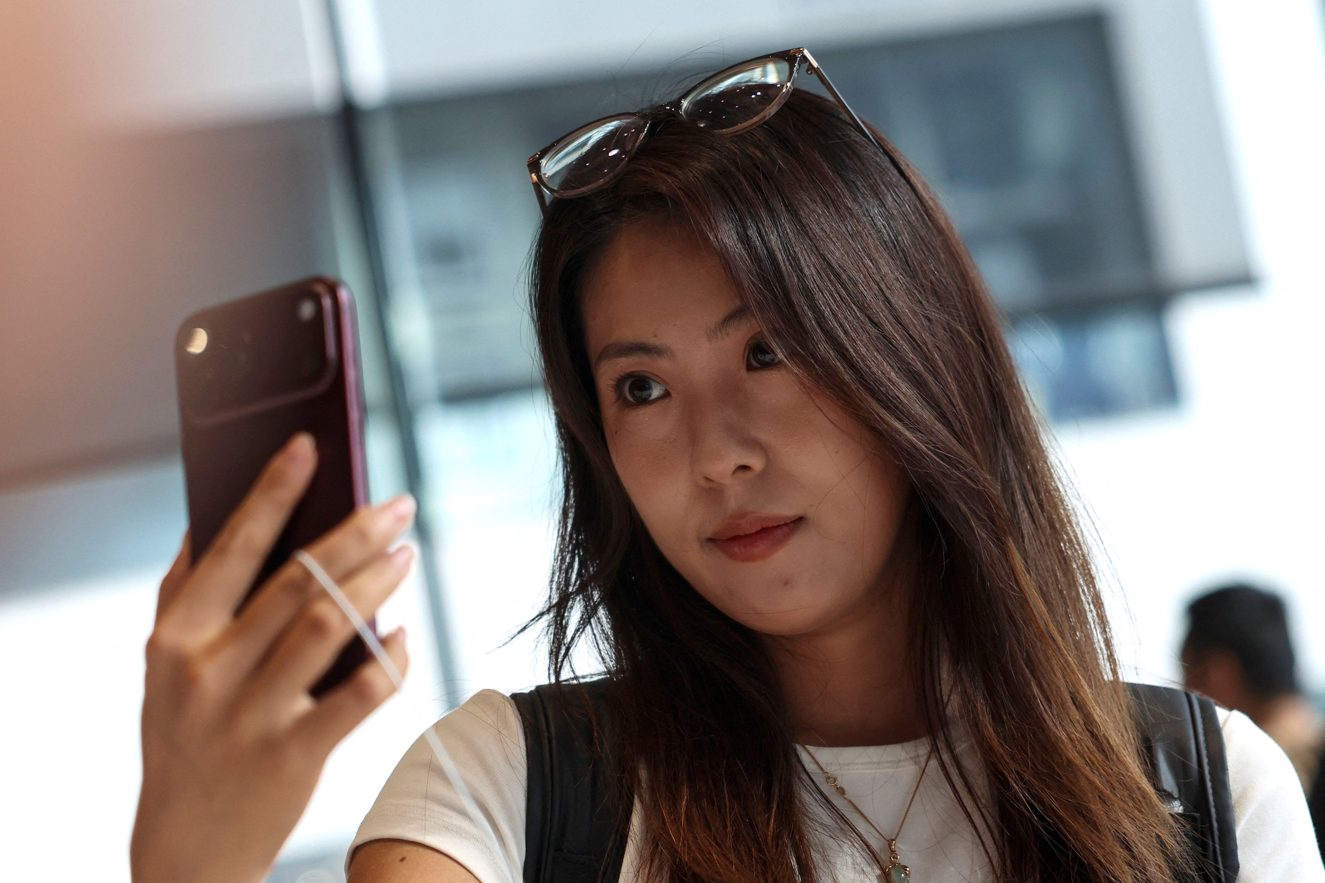 A person holding an iPhone 18. 