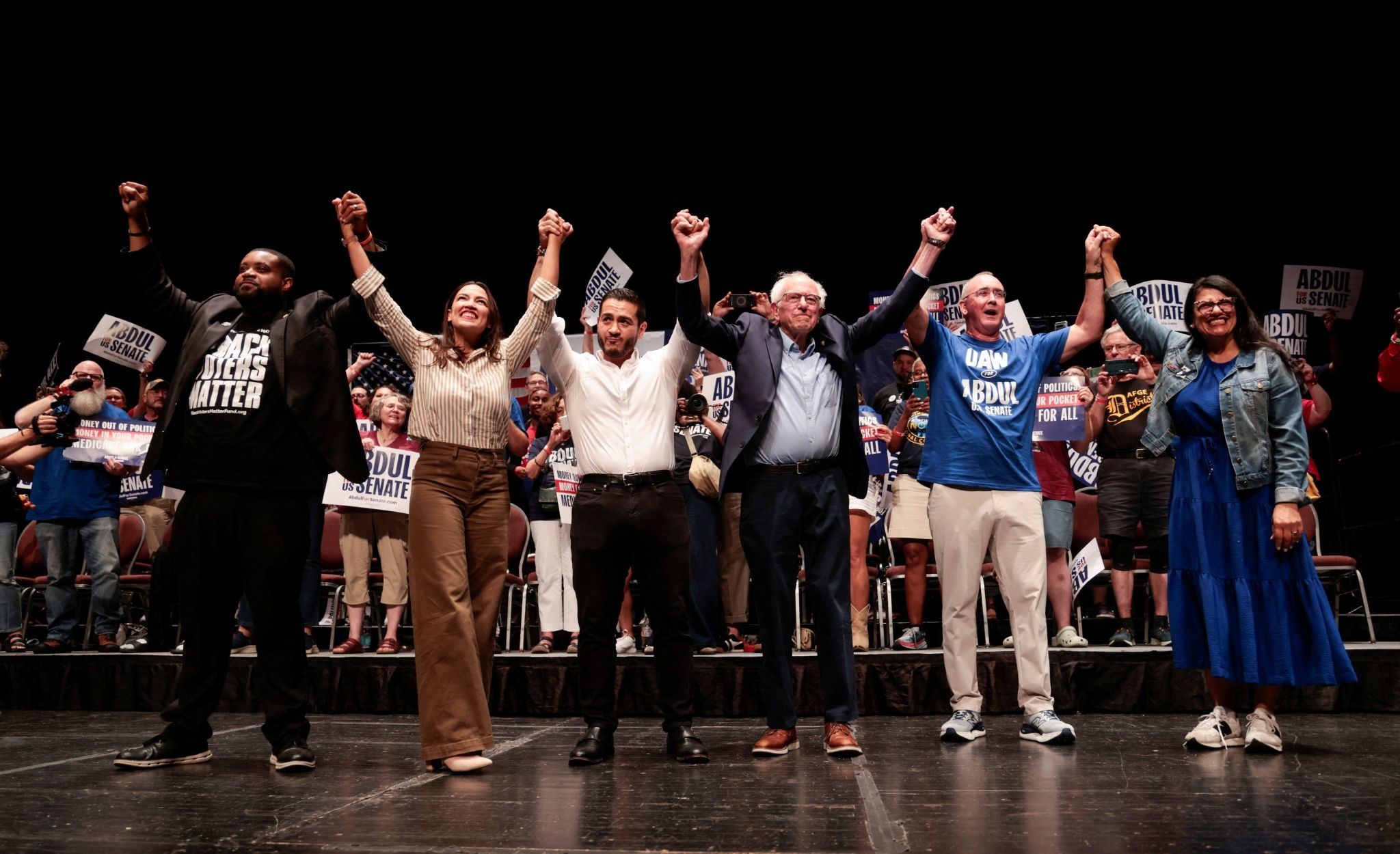 US Senate candidate Abdul El-Sayed (center-left) rallies with prominent Democrats including Congresswoman Alexandria Ocasio-Cortez and Senator Bernie Sanders. 