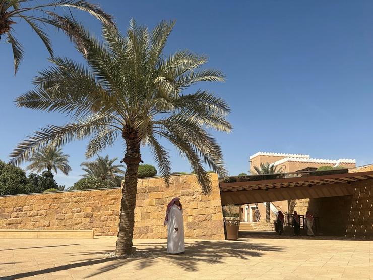 A man wearing a thawb stands under the shadow of a palm tree near the UNESCO World Heritage Site of At-Turaif, ahead of Britain’s Prince William’s visit, in Diriyah, Saudi Arabia.