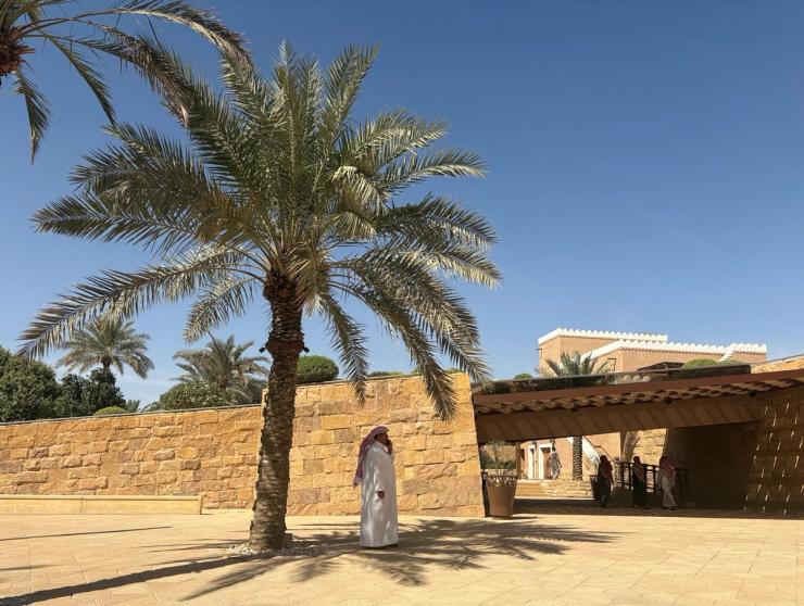 A man wearing a thawb stands under the shadow of a palm tree near the UNESCO World Heritage Site of At-Turaif, ahead of Britain’s Prince William’s visit, in Diriyah, Saudi Arabia.
