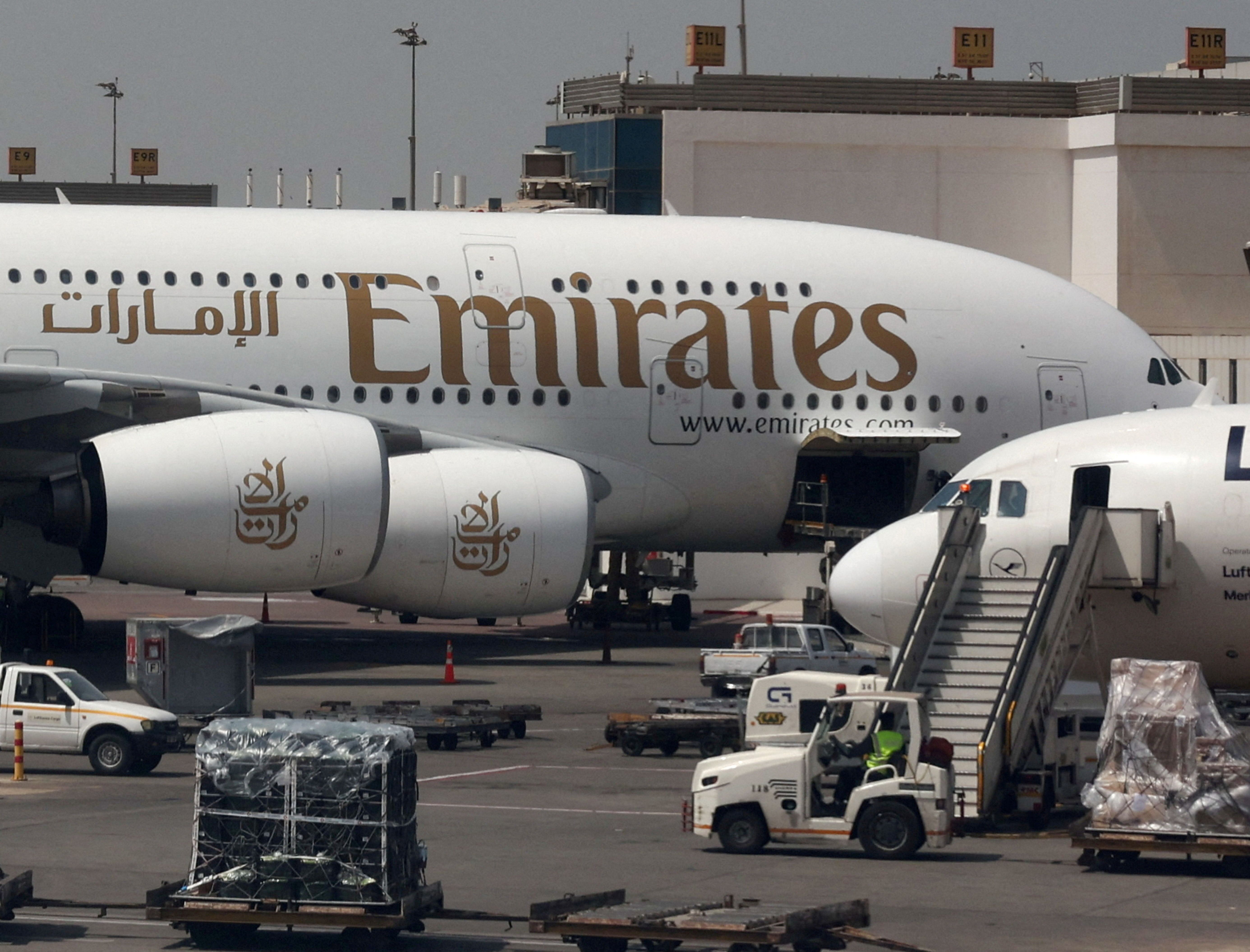 An Emirates aircraft is seen through the window of a Middle East Airlines airplane at Cairo International Airport.