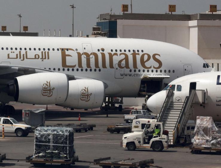 An Emirates aircraft is seen through the window of a Middle East Airlines airplane at Cairo International Airport.