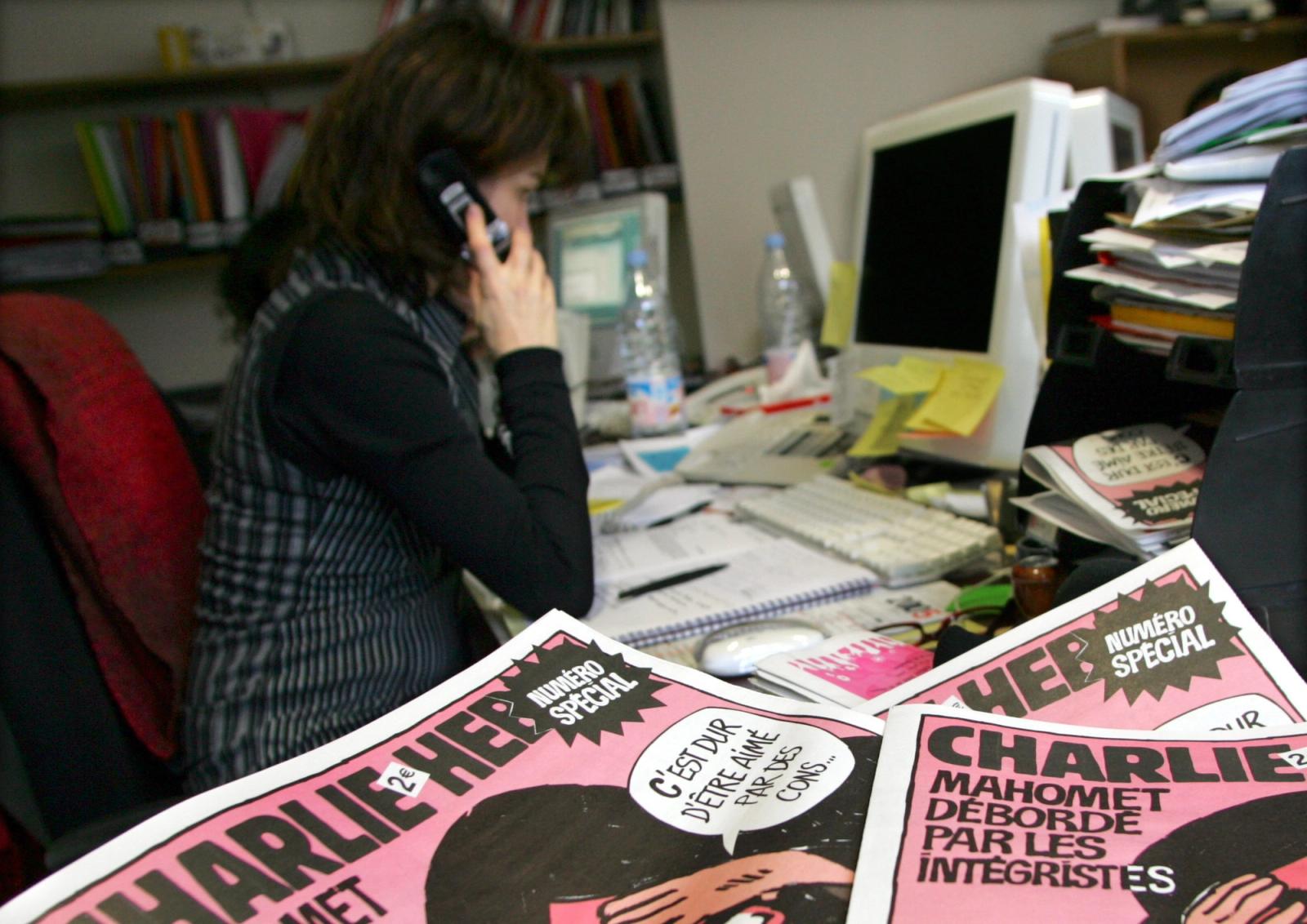 Copies of the French satirical weekly "Charlie Hebdo" seen in their Paris newsroom.
